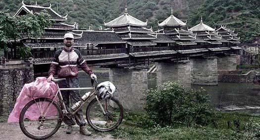 Arriving at the Song and Wind covered bridge in China on a mountain bicycle